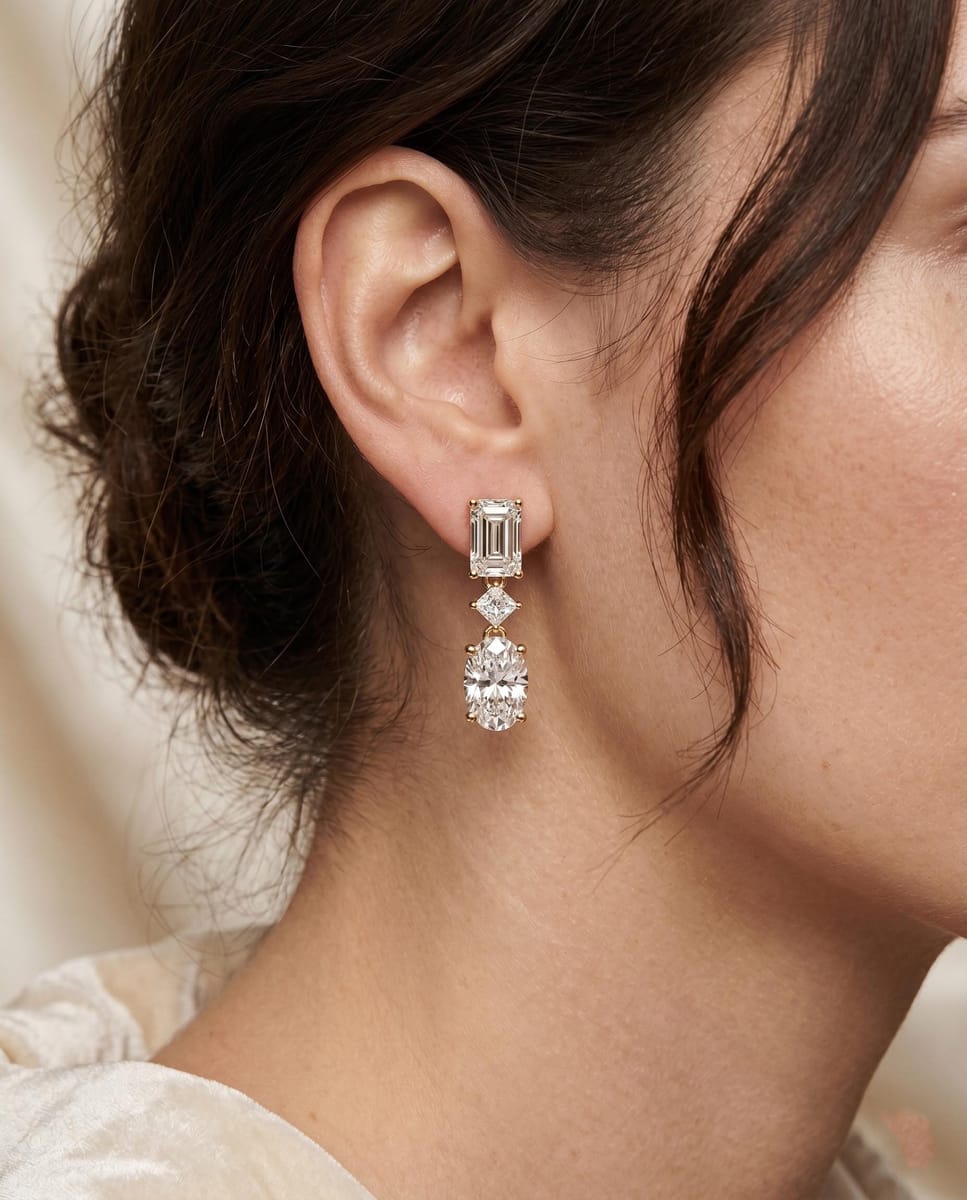 Emerald and oval-cut diamond drop earrings