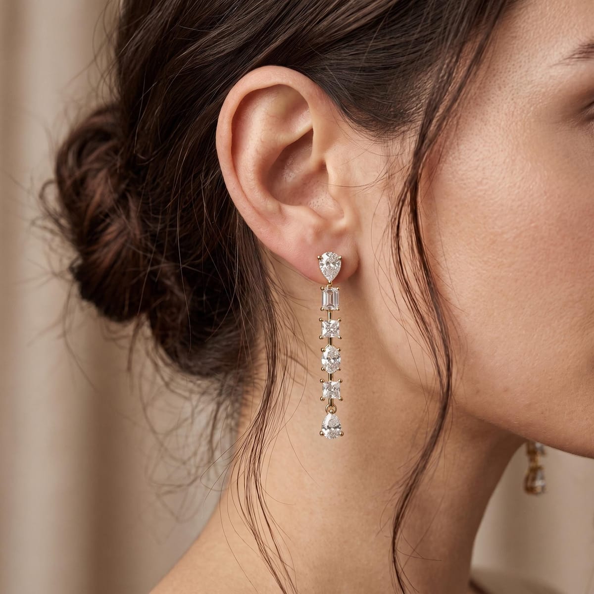 Long diamond drop earrings from the Rani collection, worn