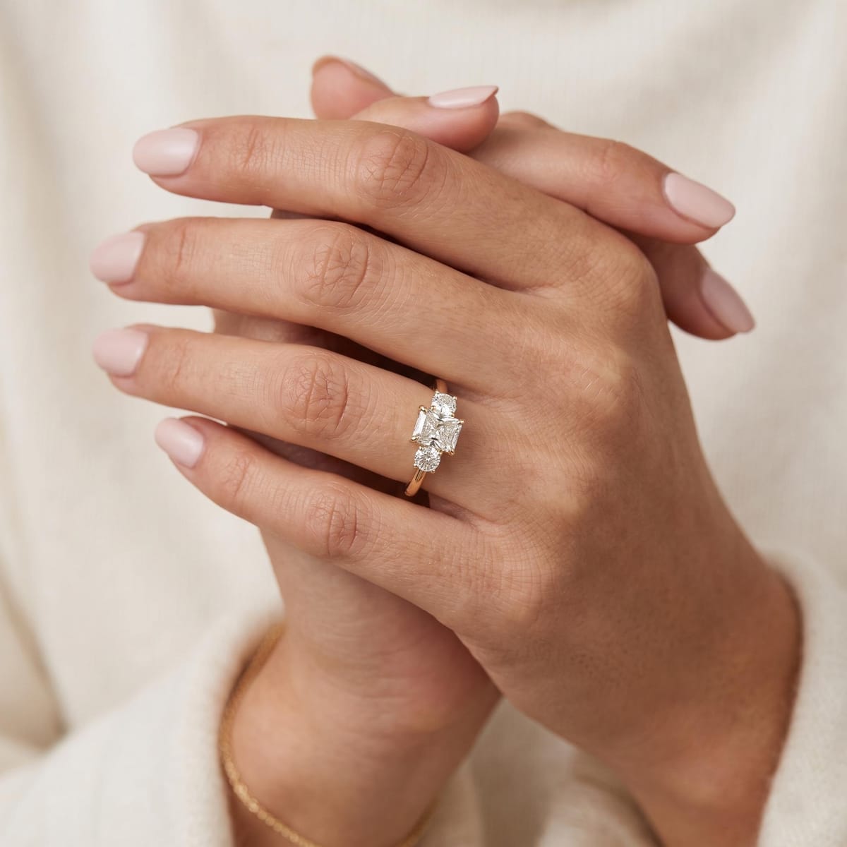 Radiant-cut three-stone engagement ring